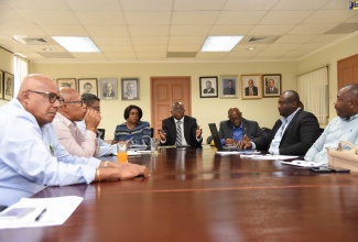 Minister without Portfolio in the Ministry of Economic Growth and Job Creation, Senator the Hon. Pearnel Charles Jr. (centre), addresses a meeting  with political representatives from the parish of St. Thomas, and officials from the National Water Commission (NWC), Rural Water Supply Limited (RWSL), Water Resources Authority (WRA) and the Jamaica Constabulary Force (JCF),  today (July 16), at his New Kingston office, to provide update on funding to truck water to drought-affected communities.  

