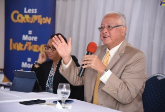 Minister of Justice, Hon. Delroy Chuck, addresses Justices of the Peace and members of the Jamaica Constabulary Force at a Child Diversion Programme Sensitisation seminar, held in Mandeville, Manchester, on August 28.