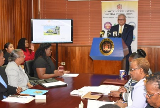 Minister without Portfolio with responsibility for Education, Youth and Information, Hon. Karl Samuda (at podium), speaks at a Press Conference to discuss the CSEC/CAPE results for 2019 at Ministry, in Kingston, on August 14. Seated are officials in the Ministry.  