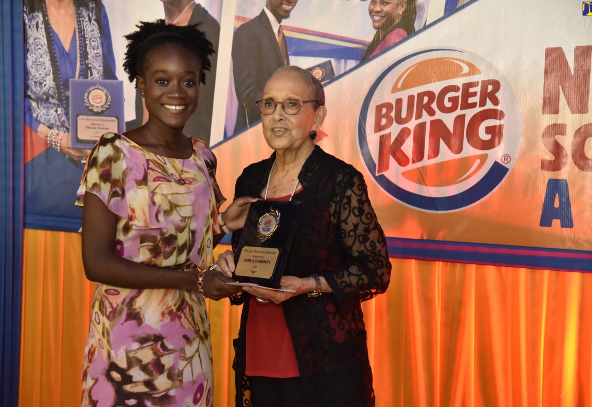 Chairman of Burger King, Lois Sherwood (right), presents the Lois Sherwood Scholarship to Amica Gordon, who will be pursuing Actuarial Science at the University of the West Indies. She was presented with her award during a ceremony held at the Terra Nova Hotel, in Kingston, on Monday, August 19.