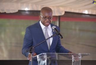 Minister without Portfolio in the Ministry of Economic Growth and Job Creation, Senator the Hon. Pearnel Charles Jr., addresses the ground breaking ceremony for the construction of 754 housing solutions at Rhyne Park Estate, in Rose Hall, St. James, on August 9.  

