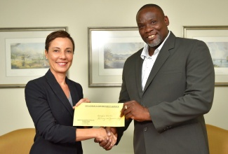 Minister of Foreign Affairs and Foreign Trade, Senator the Hon. Kamina Johnson Smith (left) and Principal of Comfort Castle Primary and Junior High School in Portland, Dalmain Moore,  display cheque for $343,350, which has been donated to the school by Canadian charity, the Tamara Gordon Foundation. The Minister handed over the cheque at the Ministry, in New Kingston,  on Tuesday (August 27). 