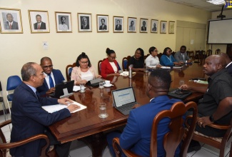 Minister of National Security, the Hon. Dr. Horace Chang (head of table), addresses a meeting of the National Task Force Against Trafficking in Persons (NATFATIP), held on Wednesday (Sept.  4),  at the Ministry in Kingston.​