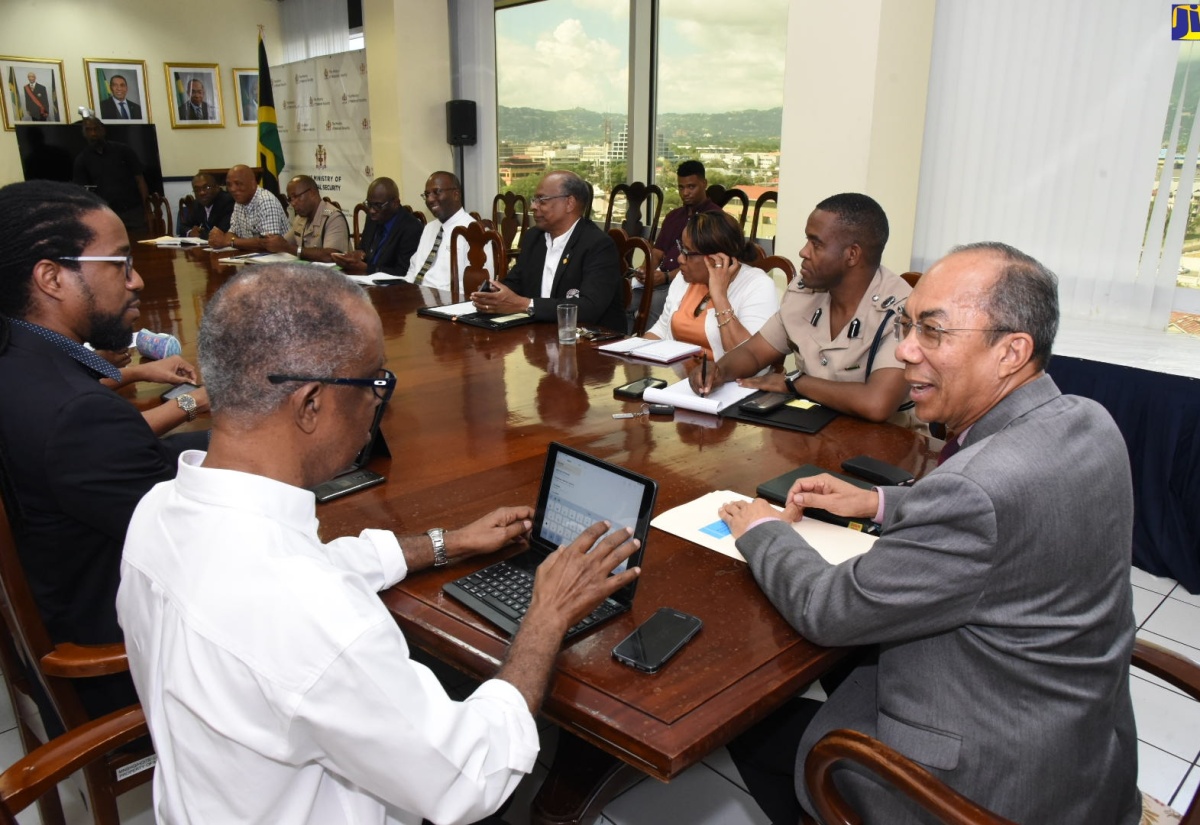 Minister of National Security, Hon. Dr. Horace Chang (left), addresses stakeholders on the Traffic Ticket Management System, at a meeting held at the Ministry in Kingston on September 12. 