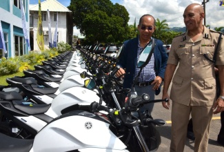 National Security Minister, Hon. Dr. Horace Chang (left), and Police Commissioner, Major General Antony Anderson, inspecting some of the 80 new motorcycles acquired for the Jamaica Constabulary Force’s (JCF) Public Safety and Traffic Enforcement Branch (PSTEB), during a handing over ceremony on Friday (September 20). The presentation was made at the Office of the Commissioner of Police in Kingston.