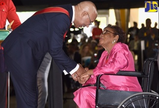 Governor-General, His Excellency the Most Hon. Sir Patrick Allen, greets 2019 national award recipient, Mrs. Norma Creary, JP, before presenting her with the Order of Distinction, Officer Class (OD), for community service, at the National Honours and Awards Ceremony, held at King’s House, on October 21. 