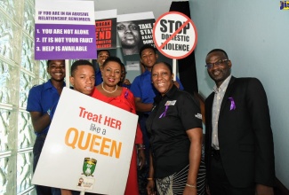 Minister of Culture, Gender, Entertainment and Sport, Hon. Olivia Grange (2nd left) along with from 2nd right: Senior Director, Gender affairs, Sharon Coburn Robinson and Permanent Secretary in the Ministry, Denzil Thorpe, share a moment with students from Jamaica College at the Stand up, Talk up Public Forum on Friday (November 29) held at the Courtleigh Auditorium in Kingston. The forum was held in commemoration of the International Day for the Elimination of Violence against Women (IDEVAW) which was observed on November 25.