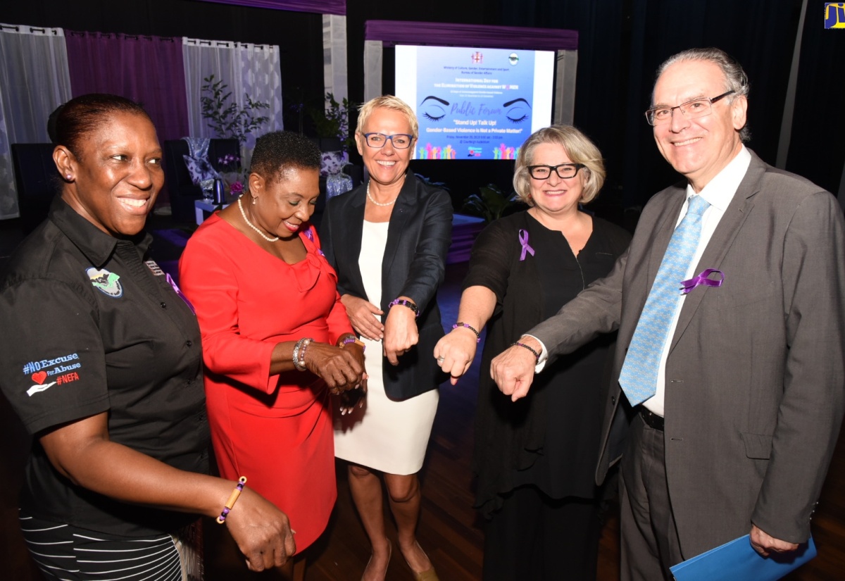 Minister of Culture, Gender, Entertainment and Sport, Hon. Olivia Grange (second left), admires her purple bracelet in commemoration of International Day for the Elimination of Violence Against Women, at the 'Stand up, Talk Up' public forum held at the Courtleigh Auditorium in New Kingston on November 29. Others showing off their bracelets (from left) are Senior Director,  Bureau of Gender Affairs (BGA), Sharon Coburn Robinson; Head of the European Union Delegation to Jamaica, Ambassador Malgorzata Wasilewska; Head of Cooperation, Canadian High Commission to Jamaica, Pascale Turcotte; and Ambassador of Spain to Jamaica, His Excellency Josep Bosch.