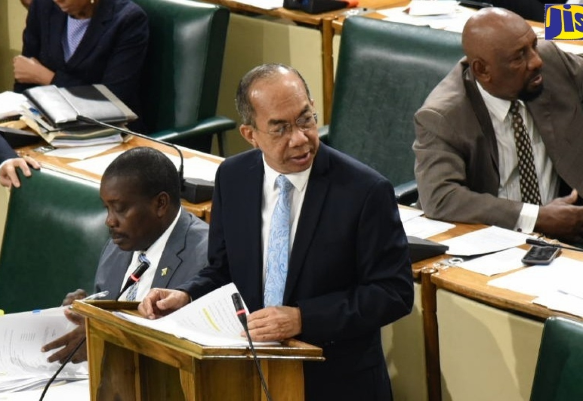 National Security Minister, Hon. Dr. Horace Chang, addresses the House of Representatives on December 10.  With the Minister are Minister of Transport and Mining, Hon. Robert Montague (left), and Minister of State in the Ministry of National Security, Hon. Rudyard Spencer.
