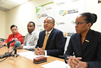 Minister of Health and Wellness, Dr. the Hon. Christopher Tufton (second right), speaking during Tuesday’s (January 28) media briefing at the Ministry’s offices in New Kingston. Listening (from left) are Pan-American Health Organization/World Health Organization (PAHO/WHO) Jamaica Country Representative, Dr. Bernadette Theodore-Gandi; Chief of Medical Staff, University Hospital of the West Indies, Dr. Carl Bruce; and Acting Chief Medical Officer, Dr. Karen Webster Kerr.