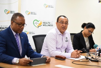 Minister of Health and Wellness, Dr. the Hon. Christopher Tufton (centre) responds to questions from journalists during a press briefing at the Ministry’s New Kingston offices on February 5, where he provided an update on Jamaica’s national emergency response and preparedness for the coronavirus. He is flanked by Permanent Secretary in the Ministry, Dunstan Bryan (left); and Chief Medical Officer, Dr. Jacquiline Bisasor-McKenzie.
