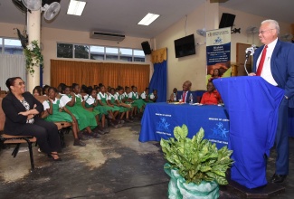 Justice Minister, Hon. Delroy Chuck addressing students and teachers at the Restorative Justice youth forum and panel discussion held on Wednesday (February 5) at the Pembroke Hall Primary School auditorium in Kingston. 