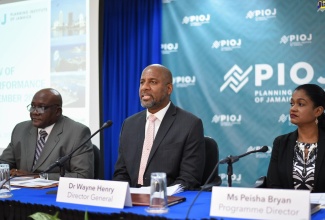 Director General for the Planning Institute of Jamaica (PIOJ), Dr. Wayne Henry (centre), addressing journalists during the PIOJ’s recent quarterly media briefing at the agency’s head office in New Kingston. Others (from left) are Senior Director for the PIOJ’s Economic Planning, Research and Policy Logistics Division, James Stewart; and Programme Director for the Vision 2030 Jamaica Secretariat at the PIOJ, Peisha Bryan.
