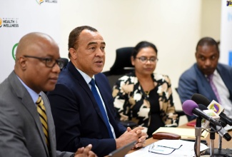 (FILE) Minister of Health and Wellness, Dr. the Hon. Christopher Tufton (centre) speaking at the press conference on Tuesday (March 10) at the Ministry’s offices in New Kingston. Seated beside him are: Permanent Secretary, Dunstan Bryan (left) and Chief Medical Officer, Dr. Jacquiline Bisasor McKenzie.
                                                 
