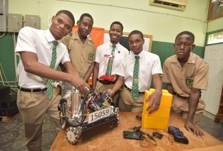 Members of the winning Calabar High School FIRST Tech Robotics Challenge team (from left): David Lynch, Tyrique Murray, Joel Tulloch, Raheem Ford and Alex Hutchinson posing with the robot that landed them the award.