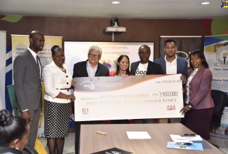Minister with oversight for Education, Youth and Information, Hon. Karl Samuda (third left) accepts a representational cheque valued at $7.4 million from Restaurants of Jamaica (ROJ), through its KFC Add Hope initiative, to boost the National School-Feeding Programme. The presentation took place recently at the Mona Heights Primary School in St. Andrew. From left are Brand Manager, ROJ, Andrei Roper; Acting Permanent Secretary in the Ministry of Education, Youth and Information, Dr. Grace McLean; Marketing Director, ROJ, Tina Matalon; international gospel artiste and Add Hope Ambassador, Kevin Downswell; Chief Executive Officer, Nutrition Products Limited (NPL), Andrew Narine; and Acting Chief Education Officer in the Ministry, Dr. Kasan Troupe.