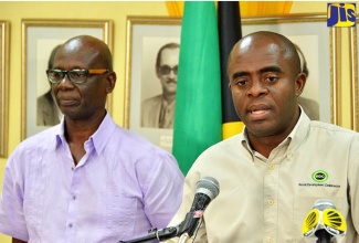 Minister of Local Government and Community Development, Hon. Desmond McKenzie (left) and Executive Director of the Social Development Commission (SDC), Dr. Dwayne Vernon. The SDC has committed its support to the dissemination of COVID-19 information to communities islandwide and to provide information on communities and other areas deemed critical by the Government of Jamaica.