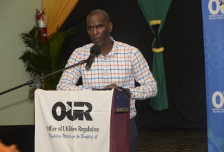 Chief Financial Officer (CFO), Jamaica Public Service (JPS) Company, Vernon Douglas, addresses residents and stakeholders during the Office of Utilities Regulation (OUR) Public Consultation on the JPS’s 2019-2024 tariff review at the Sharon Baptist Church in Santa Cruz, St. Elizabeth, recently.
