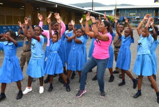 Behaviour Change Officer at the Ministry of Health and Wellness, Julia Manderson Steele (centre), engages students at the Clan Carthy Primary School in St. Andrew in ‘Jamaica Moves’ activities at the school.