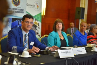 President and Chief Executive Officer of JPS, Emanuel DaRosa (left), speaks at the recent Energy Climate Partnership of Americas (ECPA) Ministerial Meeting, held at the Montego Bay Convention Centre, in St. James. Listening (from second left) are Deputy Assistant Secretary for Asia and the Americas at the Office of International Affairs in the US Department of Energy, Beth Urbanas; and Minister of Science, Energy and Technology, Hon. Fayval Williams. 