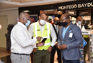 Director of Tourism, Donovan White (left) engages Minister of Health and Wellness, Hon Christopher Tufton (centre) and Minister of Tourism, Hon Edmund Bartlett in dialogue regarding arrangements for the restart of Jamaica’s tourism industry with the first set of flights arriving at the Sangster International Airport today (June 15).