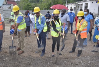 Minister of Health and Wellness, Dr. the Hon. Christopher Tufton (left), participates in the breaking of ground for the construction of the $200 million, Buff Bay Health Centre, in Portland, on June 12. Others (from 2nd left) are: Member of Parliament for West Portland and Minister without portfolio in the Ministry of Economic Growth and Job Creation, Hon. Daryl Vaz; Member of Parliament for Eastern Portland, Ann-Marie Vaz; and Health Promotion and Public Relations Manager at the National Health Fund (NHF), Shermaine Robotham.