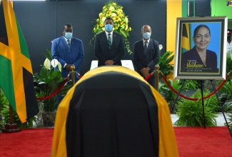 Prime Minister, the Most Hon. Andrew Holness (centre); Minister of Transport and Mining, Hon. Robert Montague (left); and Minister of National Security,  Hon. Dr. Horace Chang, view the closed casket of the late Minister of Labour and Social Security, Hon. Shahine Robinson, at the Jamaica Labour Party (JLP)  headquarters on Belmont Road in St. Andrew, on Tuesday (June 16).  