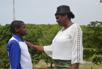 Keville Cunningham Jr. (left) in dialogue with proud mom, Racquel Brown-​Cunningham. Keville was placed at Cornwall College in St. James after being successful in his Primary Exit Profile (PEP) exams.

