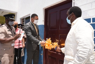 Prime Minister, the Most Hon. Andrew Holness (centre) along with Minister of Transport and Mining, Hon. Robert Montague (right) cut the ribbon to officially open the Gayle Police Station and Multi-Purpose Centre in St. Mary on Friday (July 10). Looking on is Assistant Commissioner of Police, Area Two Police Division, Elbert Nelson.

 