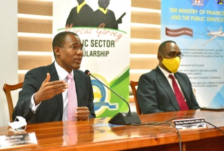 Minister of Finance and the Public Service, Dr. the Hon. Nigel Clarke (left), emphasises a point while speaking at Wednesday's (July 29) virtual launch of the Marcus Garvey Public Sector Scholarship Programme, at the Ministry's offices in Kingston. With the Minister is Jamaica Civil Service Association President, O'Neil Grant .
