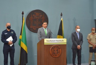 Prime Minister, the Most Hon. Andrew Holness (second left), addresses  a virtual press briefing at the Office of the Prime Minister Media Centre  in Kingston, on Wednesday (July 8).

With the Prime Minister (from left) are Commissioner of Police, Major General Antony Anderson; Minister of National Security , Hon. Dr. Horace Chang; and Chief of Defence Staff, Lieutenant General Rocky Meade.