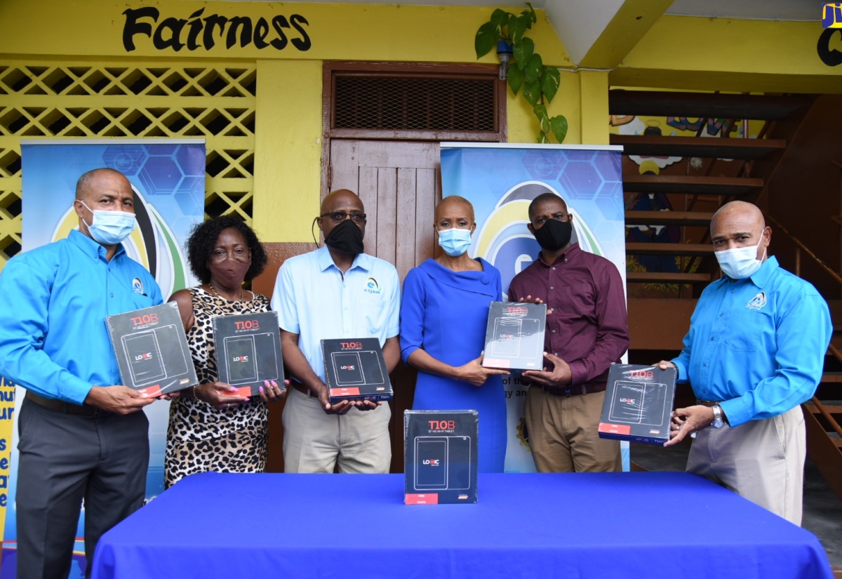 Education, Youth and Information Minister, Hon. Fayval Williams (fourth left) holds one of the 146 tablets distributed to the Holy Family Infant and Primary School during a ceremony held on October 2 at the school, located at Laws Street, downtown Kingston. The initiative falls under the government’s Tablets in Schools programme. Also taking part (from left) are Chief Operating Officer, e-Learning Jamaica Company Limited, Andrew Lee; Guidance Counsellor, Holy Family Infant and Primary School, Marcia Richards; Chief Executive Officer (CEO), e-Learning Jamaica Company Limited, Keith Smith; Principal of Holy Family Infant and Primary School, Christopher Wright; and Chair of the Board of Directors, e-Learning Jamaica Company Limited, Christopher Reckord.