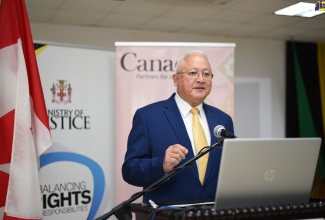 Minister of Justice, Hon. Delroy Chuck, addresses a ceremony for the handover of  the Witness Care Strategy and Action Plan to stakeholders in the justice system, at the Ministry in Kingston on Wednesday (October 28). 

