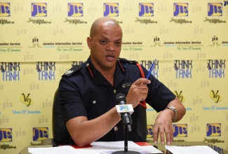 Officer in Charge of the Fire Prevention Division and Public Relations Officer at the Jamaica Fire Brigade (JFB), Emeleo Ebanks, demonstrates the acceptable distance for assembly points away from multistorey buildings, at a recent JIS 'Think Tank'. 
