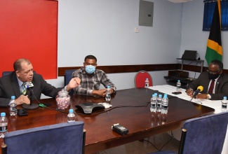 Member of Parliament for North East Manchester, Hon. Audley Shaw (left), emphasises a point during a meeting with Custos of Manchester. Garfield Green (right); and Members of Parliament (MPs) for the parish held in Williamsfield on Thursday (September 24). Member of Parliament for South Manchester, Robert Chin, listens.