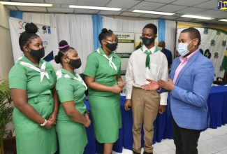 Minister of Agriculture and Fisheries, Hon. Floyd Green (right), interacts with 4-H clubbites from Kingston and St. Andrew, at the launch of the Youth in Agriculture Roadmap, on November 12, at the Ministry in Kingston.
