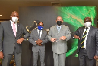 Minister of Industry, Investment and Commerce, Hon. Audley Shaw (second right), exchanges greetings with (from left): Director General and Chairman of the Planning Institute of Jamaica (PIOJ), Dr. Wayne Henry; State Minister in the Ministry, Hon. Dr. Norman Dunn; and Chairman of the Hazardous Substances Regulatory Authority (HSRA), Professor Ishenkumba Kahwa. The occasion was the virtual launch of the HSRA on October 29.

