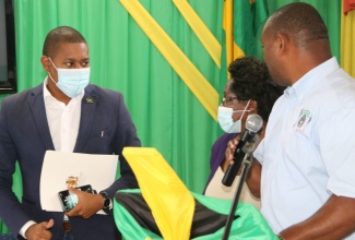 Minister of Agriculture and Fisheries, Hon. Floyd Green (left), engages in discussion with from (centre), Secretary of the Jamaica Association of Sugar Technologists (JAST), Rev. Paulette Wright and President, Michael Martin, at the 83rd annual conference of the JAST at the Sugar Industry Authority Conference Centre in Mandeville on November 5.