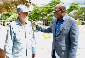 Minister of Tourism, Hon. Edmund Bartlett (right);​ and GoldenEye's owner and music mogul, Chris Blackwell, at the launch of the James Bond movie, No Time To Die, at GoldenEye resort in 2019.