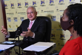 Minister of Justice, Hon.  Delroy Chuck, addresses a recent JIS Think Tank at the agency's head office in Kingston.

