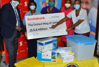 Principal of the Gwen Neil Basic School in St. Catherine, Sandra Young (right), points to the symbolic cheque for $6.6 million for the procurement of equipment and supplies​ to benefit 51 early-childhood institutions across the island.  Occasion was a ceremony for the handover of the items donated by United Way of Jamaica in partnership with Scotia Bank, at the Early Childhood Commission (ECC) in Kingtson on Tuesday (December 15). Sharing the moment (from left) are Immediate Past President, United Way of Jamaica, Ian Forbes; Vice President, Corporate Affairs and Communication, Scotiabank, Yanique Forbes-Patrick; Chief Executive Officer, United Way of Jamaica, Winsome Wilkins; and Chairman, Early Childhood Commission, Trisha Williams-Singh.

 