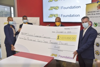 Education, Youth and Information Minister, Hon. Fayval Williams (left), displays cheque for over $2 million handed over by the JPS Foundation to pay the  examination fees of 514 students registered to sit the CSEC Industrial Technology (Electrical) examination in 2021. The handover of the cheque to the Overseas Examinations Commission (OEC) was held at the JPS head office in New Kingston, on Wednesday (December 9). She is assisted by (from second left)  Examinations Officer, Caribbean Secondary Education Certificate (CSEC) and Caribbean Vocational Qualifications (CVQ), OEC, Tanjay Holmes; Deputy Chairman of Jamaica Public Service Company (JPS) Foundation, Ramsay McDonald and President and Chief Executive Officer (CEO), JPS, Michel Gantios. 

