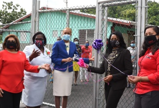 Minister of Education, Youth and Information,  Hon. Fayval Williams (centre); and Member of Parliament for St. Thomas Eastern, Dr. Michelle Charles (second right), cut the ribbon to open the newly renovated Pear Tree River Special Needs School, formerly called Pear Tree Primary, in St. Thomas, on Wednesday (December 16). Also participating (from left) are Chairperson of the Digicel Foundation, Jean Lowrie-Chin; Acting Principal of Lyssons Centre of Excellence, Jacqueline Hendricks;  and Chief Executive Officer of Digicel, Charmaine Daniels. 