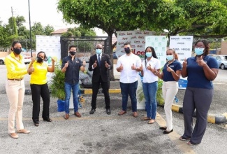 Minister of Housing, Urban Renewal, Environment and Climate Change Hon. Pearnel Charles Junior celebrates with Recycling Partners of Jamaica, Magna Rewards, Lee’s Food Fair and NEPA on the successful launch of the National Supermarket Plastic Recyclables drop off centre programme. Looking on are: L-R- Kashta Graham, Project Manager, Plastic Waste Minimization Project, Lisa Kirkland, Manager, Pollution Monitoring and Assessment Branch, NEPA, Patrick Lee of Lee’s Food Fair Ltd., Jonathan Beckford, Logistics Officer and Candice Ming, Public Relations Manager of Recycling Partners of Jamaica, Avadawn Weir, Accounts Manager, and Sereta Thompson, Senior Accounts Manager of Magna Rewards