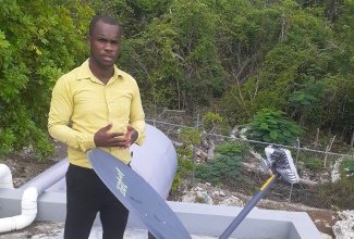 Principal of Little Bay Primary and Infant School in Westmoreland, Keron King, shows off the satellite dish, which powers the school’s Internet, provided by the Ministry of Education, Youth and Information through partnership with ReadyTV under its ReadyNet satellite Internet service.

