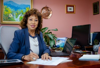 Diane Edwards, President of JAMPRO signing the MOU.