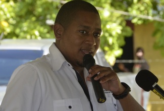 Minister of Agriculture and Fisheries, Hon. Floyd Green, speaking at function for the handover of a backhoe to the St. Elizabeth Rural Agricultural Development Authority (RADA) at the Holland Estate in the parish, recently.