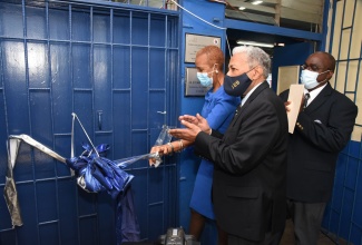 Minister of Education, Youth and Information, Hon. Fayval Williams (left), cuts the ribbon to officially open the STEAM Laboratory that was donated by Jamaica College Old Boy, Veterinarian, Dr. Joseph Tait, during a ceremony held at Jamaica College, Wednesday (January 27).  Sharing the moment (from second left) are Dr. Tait and Principal at Jamaica College, Wayne Robinson.