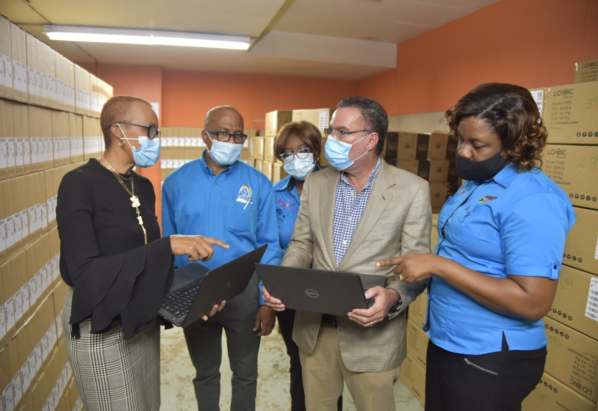 Minister of Education, Youth and Information, Hon. Fayval Williams (left) and Minister of Science, Energy and Technology, Hon. Daryl Vaz (2nd right ) examine new laptops during a ceremony held on Friday (January 15) at the Post and Telecommunications Department, South Camp Road in Kingston. Others from (second left) are: Acting Chief Executive Officer, e-Learning Jamaica, Andrew Lee; Operations Manager, Postal Corporation of Jamaica, Marcia Higgins and Deputy Post Master General, Postal Corporation of Jamaica, Sophia Hamilton Brown.