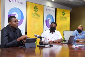 Minister of State in the Ministry of Education, Youth and Information, Hon. Robert Morgan (left), addresses the launch of a partnership between the Supreme Ventures Foundation and EduFocal, to provide 5000 students with free access to EduFocal’s learning platform. The function took place on Friday (Jan. 22), at Supreme Ventures Limited’s (SVL) offices in Kingston. Listening are Chief Executive Officer of EduFocal, Gordon Swaby (centre) and Vice President for Marketing and Communications at SLV, Gail Abrahams.